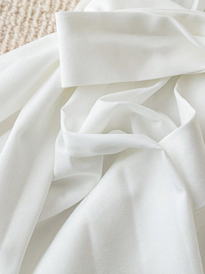White shirt with tied waist ribbon and pleated fabric detail