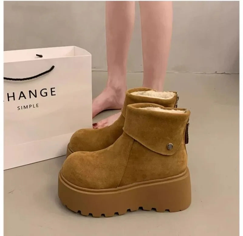 Tan wool-lined ankle boots with button strap and thick lug sole