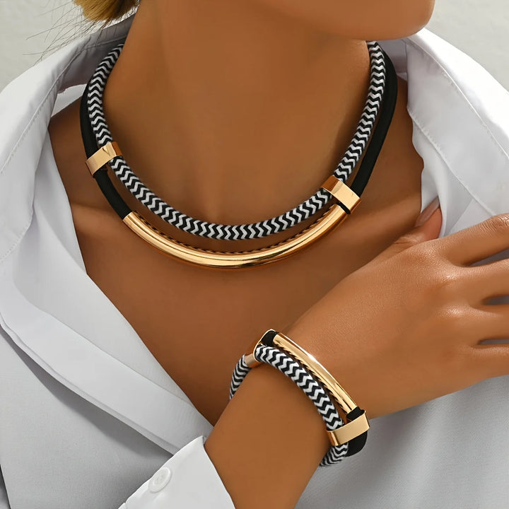Necklace and bracelet set with black and white pattern worn by a person