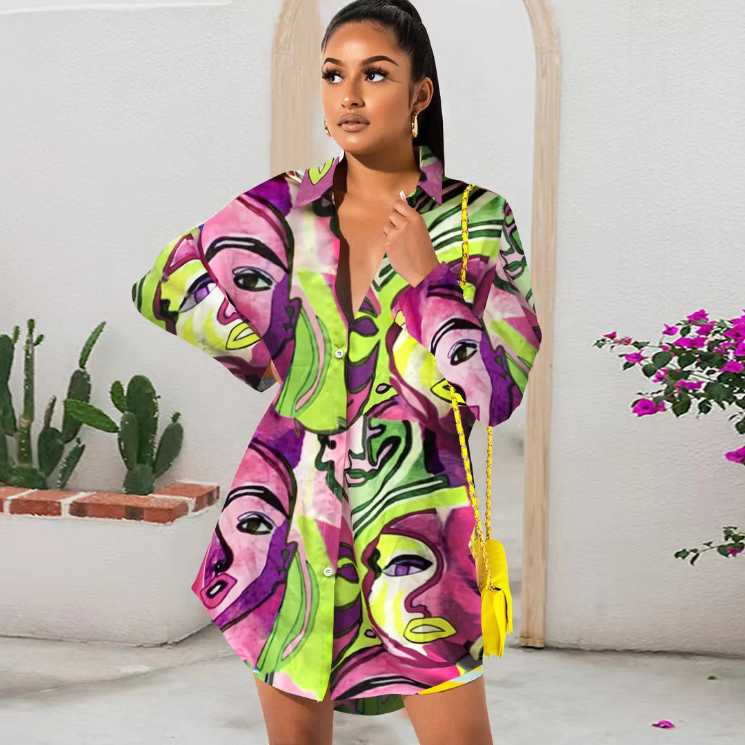 Woman wearing a colorful dress with abstract face designs in a minimal indoor setting.