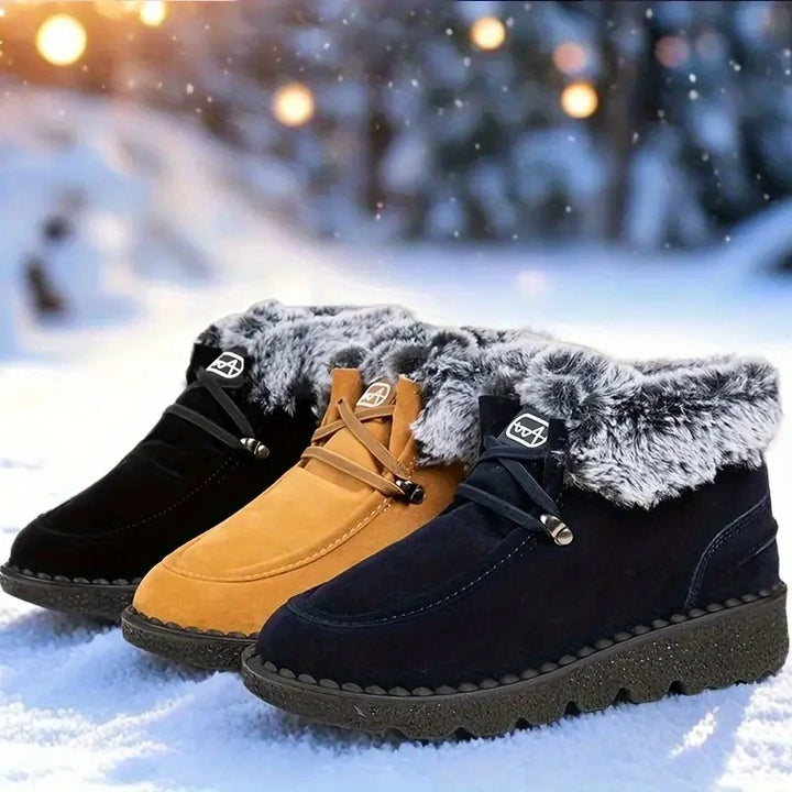 Pair of women's winter snow boots in tan and black with faux-fur cuffs