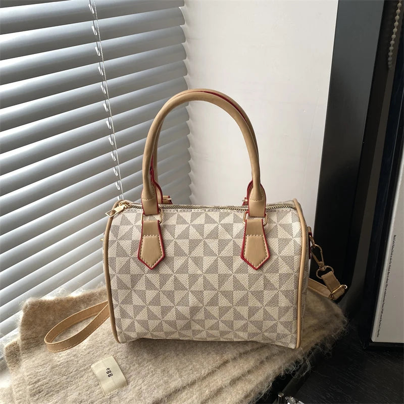 White PU handbag with geometric triangle print, zip-top, top handles, and adjustable strap