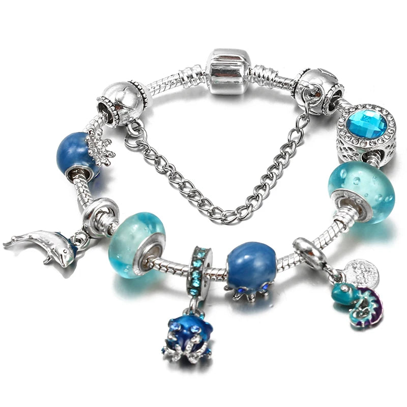 Silver charm bracelet with blue and turquoise beads and heart and star-shaped charms
