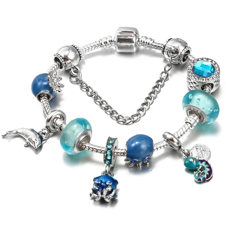 Silver charm bracelet with blue and turquoise beads and heart and star-shaped charms