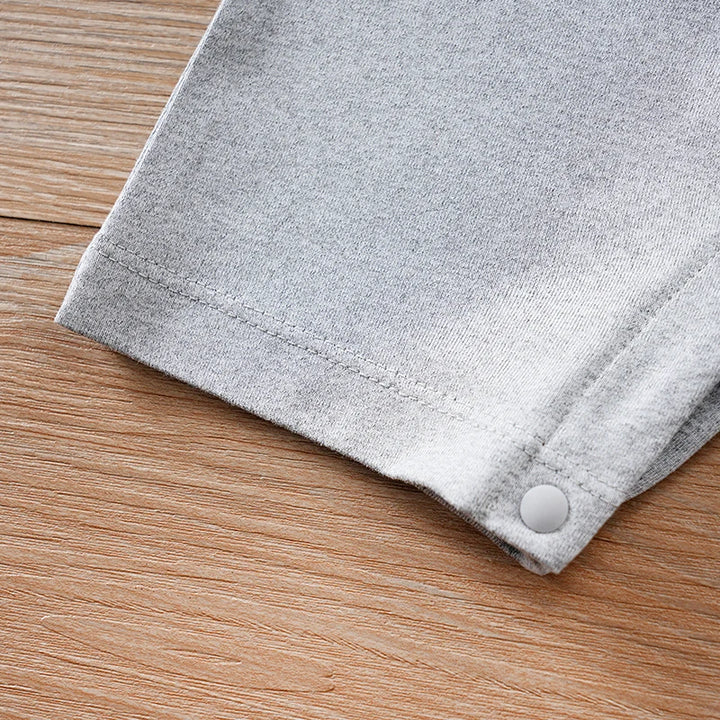 Gray fabric with a button on a wooden surface