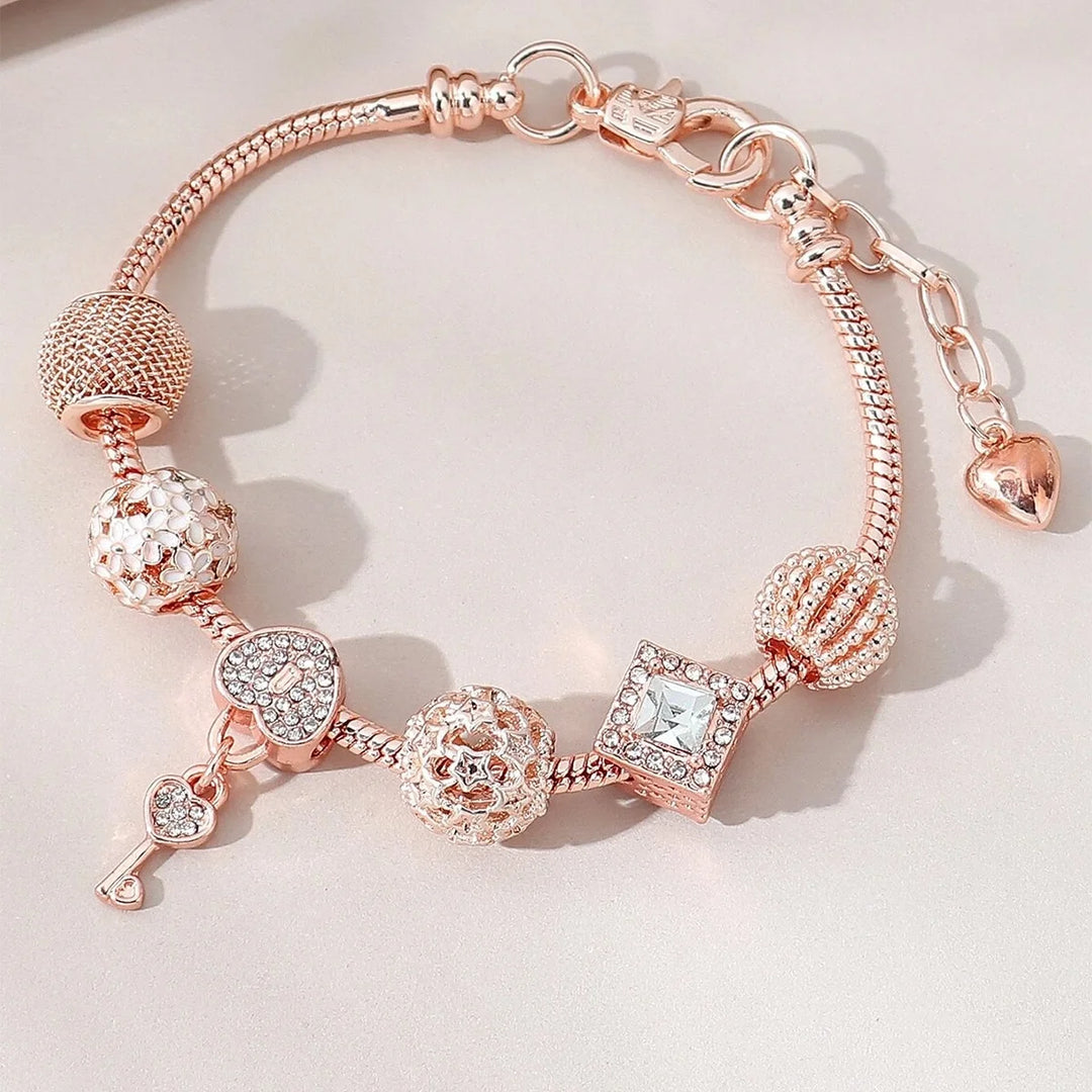 Rose gold charm bracelet with rose, heart, and sparkling crystal square bead charms