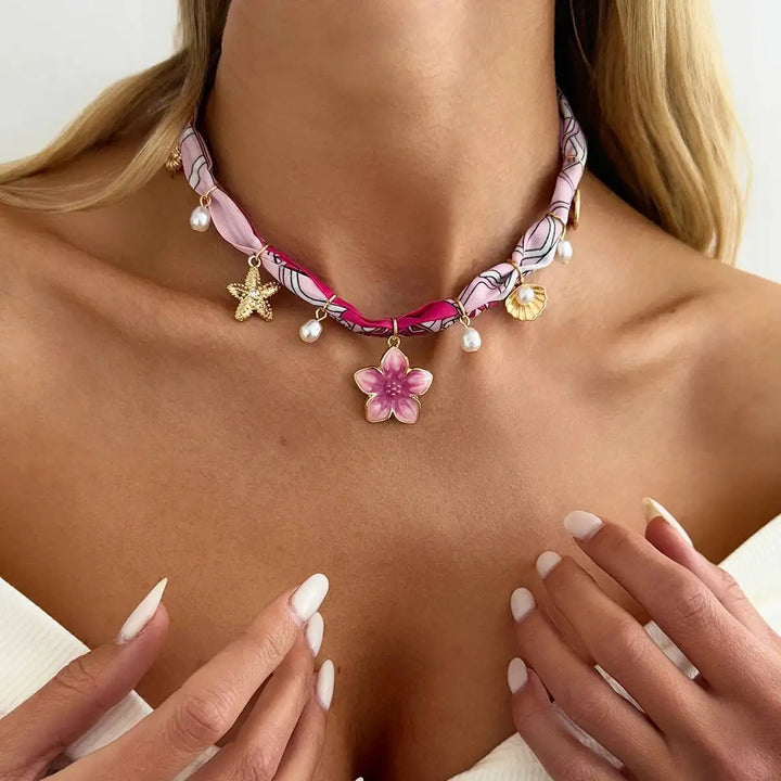 Pink flower charm boho necklace with beaded drops and gold-tone star charm