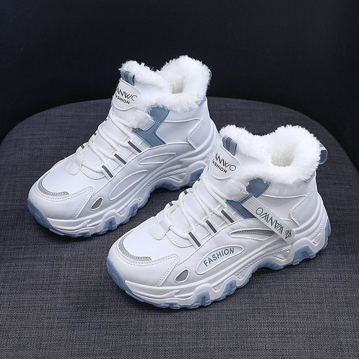 White high-top sneakers with blue accents on a dark surface
