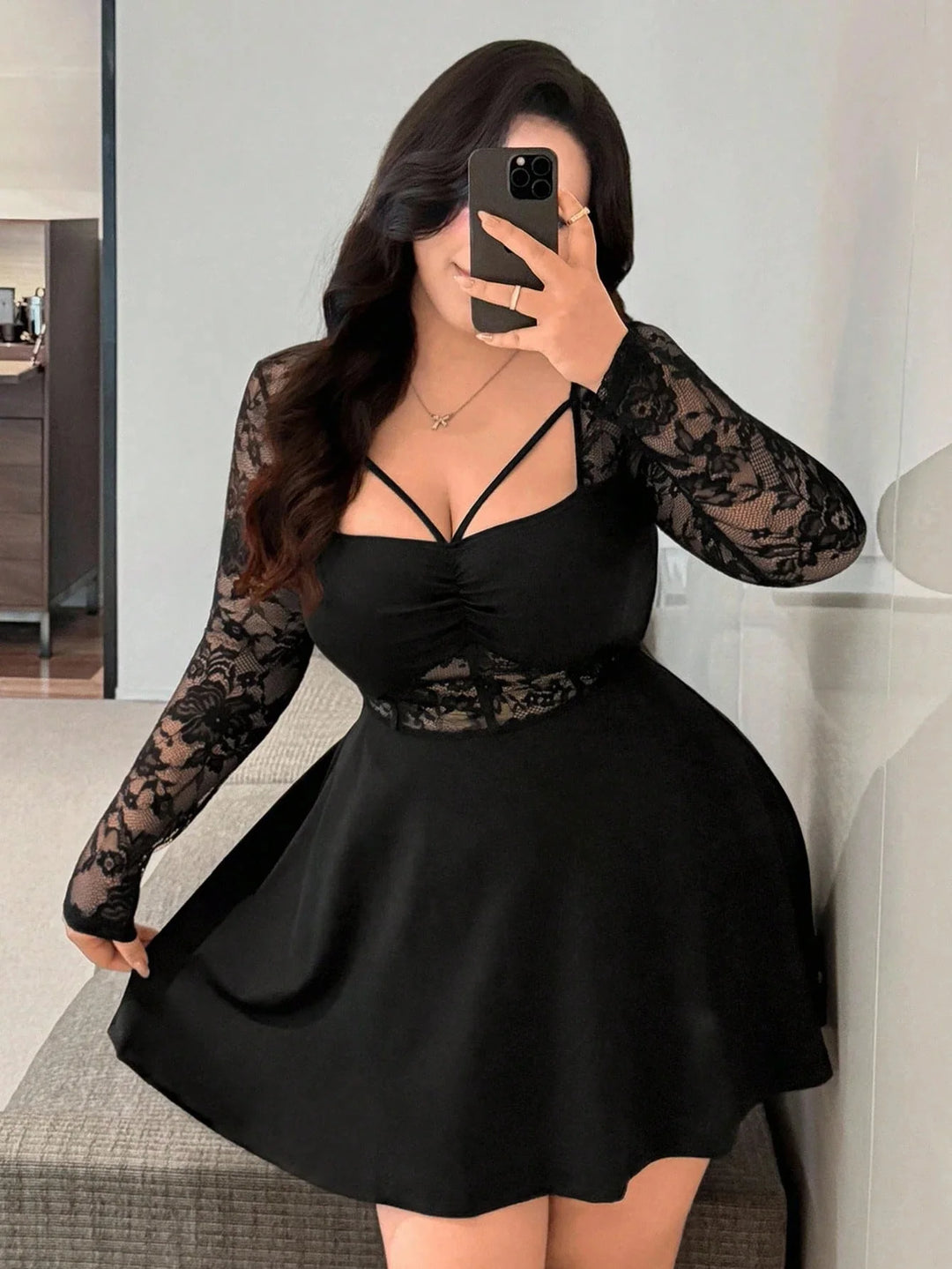 Black lace long sleeve mini dress with V-neck and strappy front, ruched waist