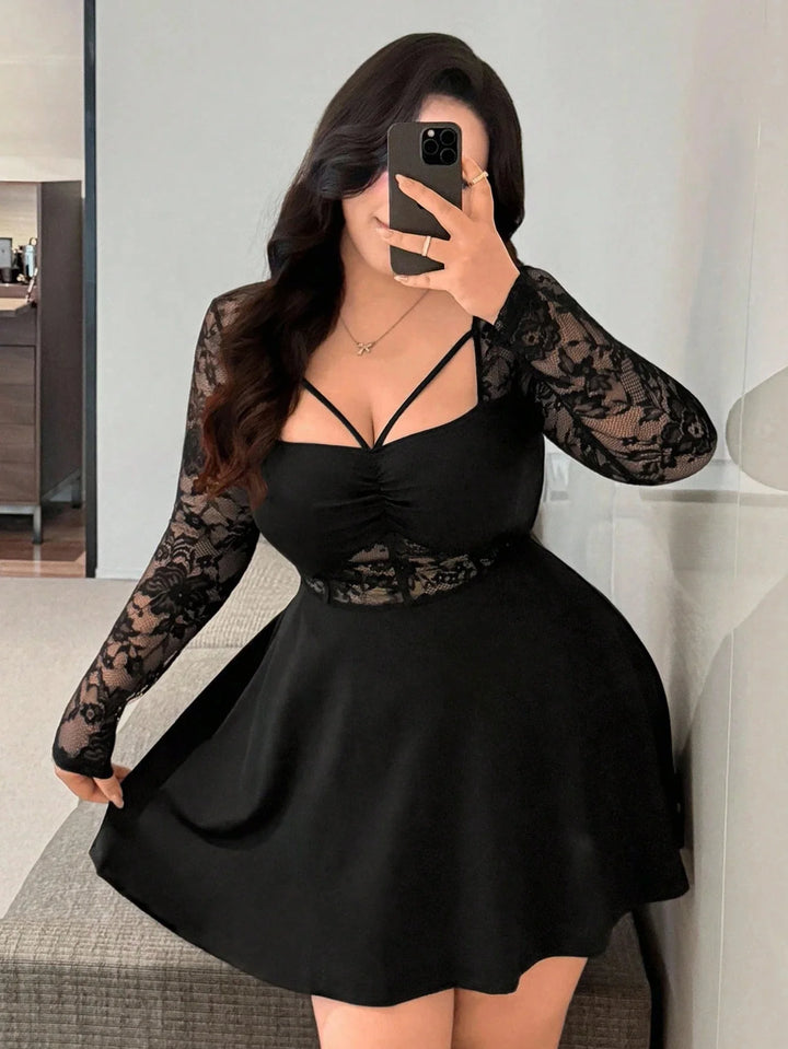 Black lace long sleeve mini dress with V-neck and strappy front, ruched waist