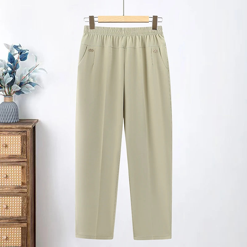 Light beige loose pants with an elastic waist and angled pockets
