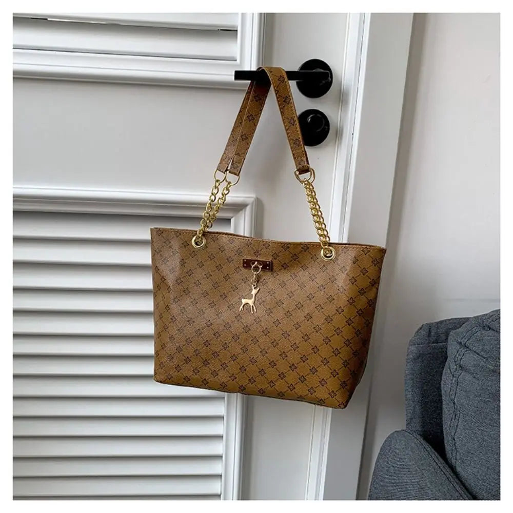 Large patterned bucket tote bag with chain handles and top clasp, brown/tan