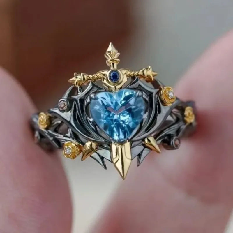 Heart-shaped blue zircon thorn-wrapped ring with gold spikes, adjustable open band