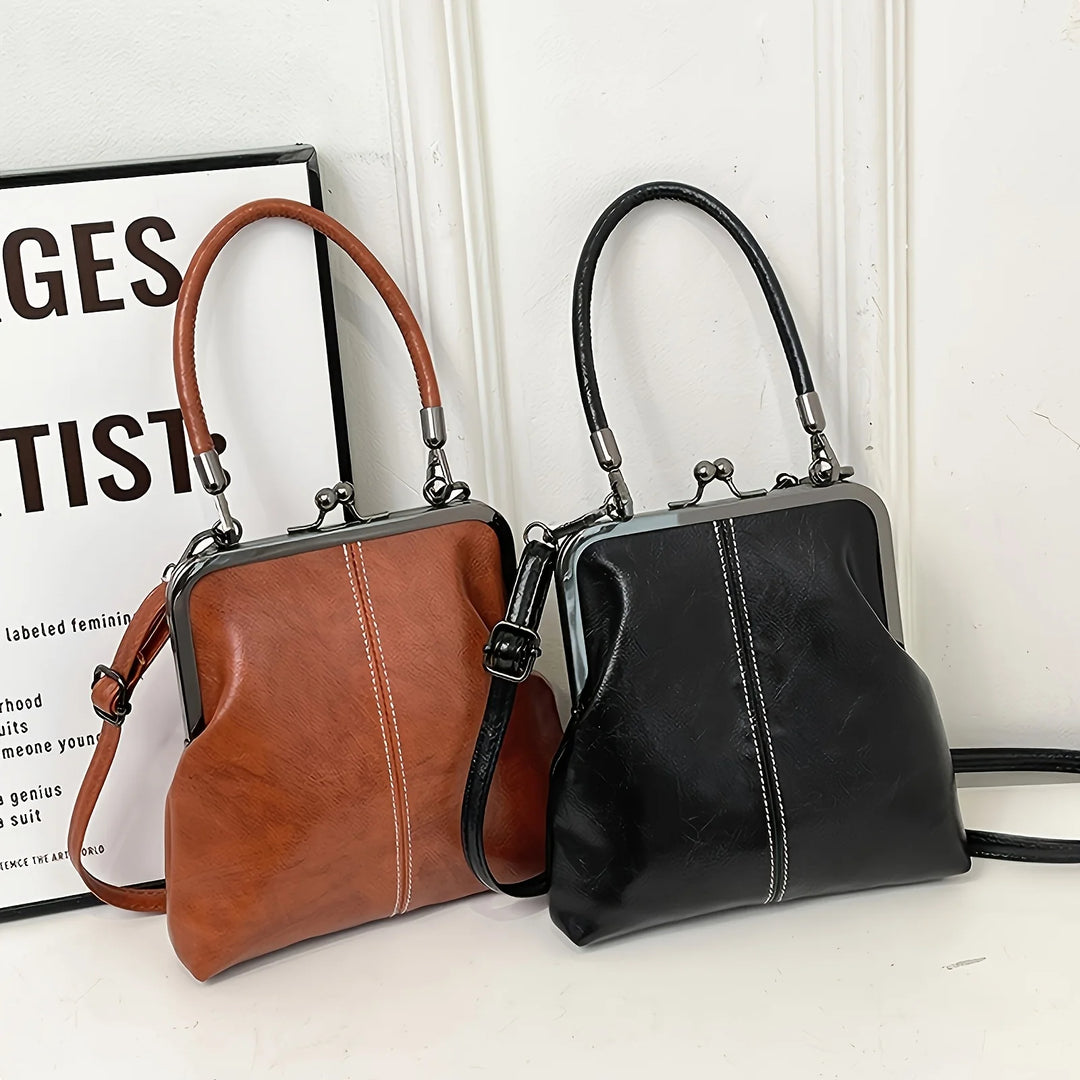 Brown and black handbags on a white surface with a blurred background