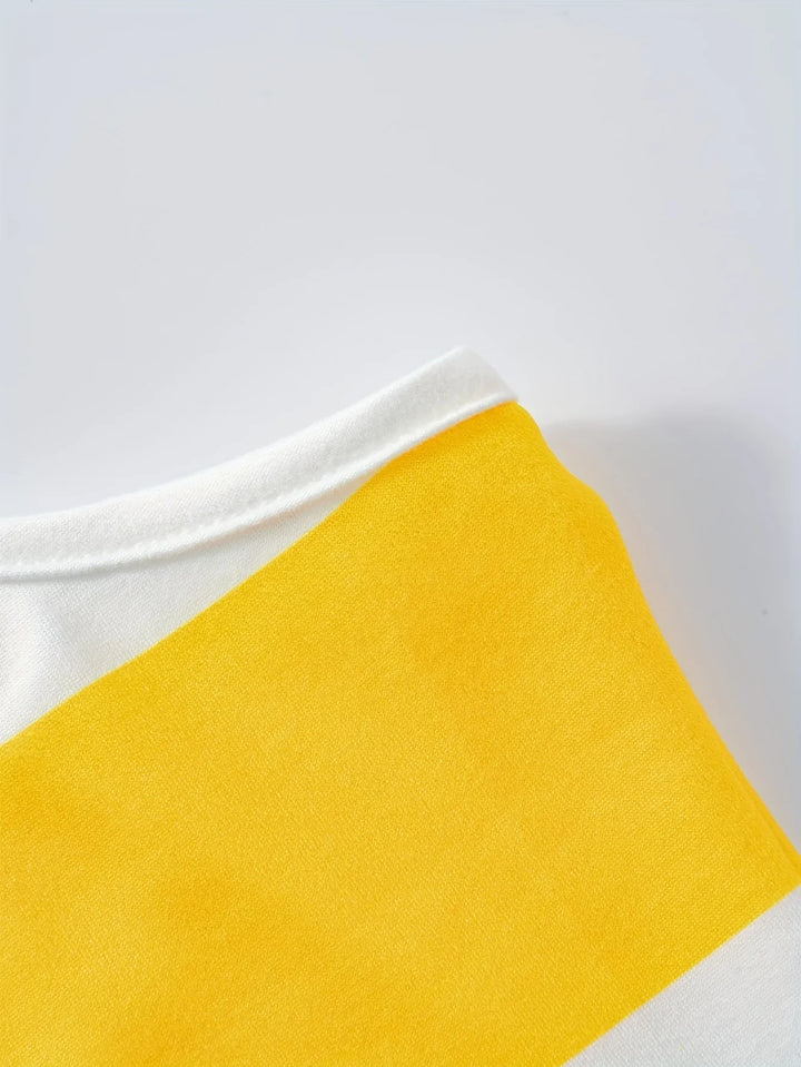 Close-up of a yellow fabric swatch on a white background