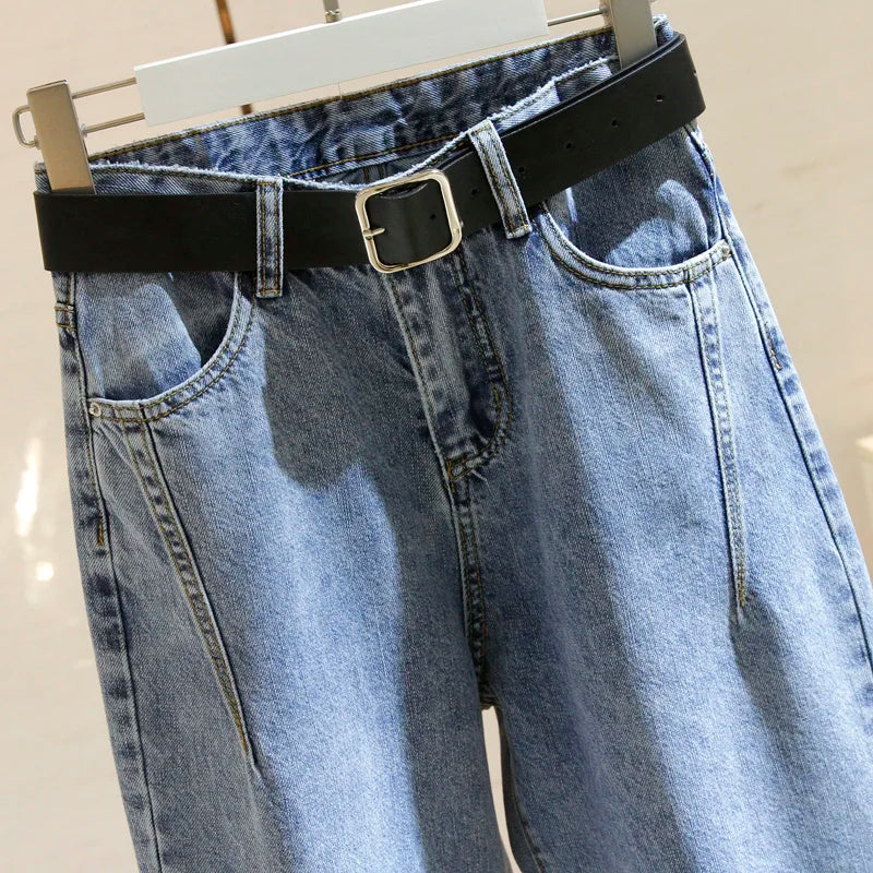 Women’s denim harem jeans waistband with black belt, buckle detail, front button placket