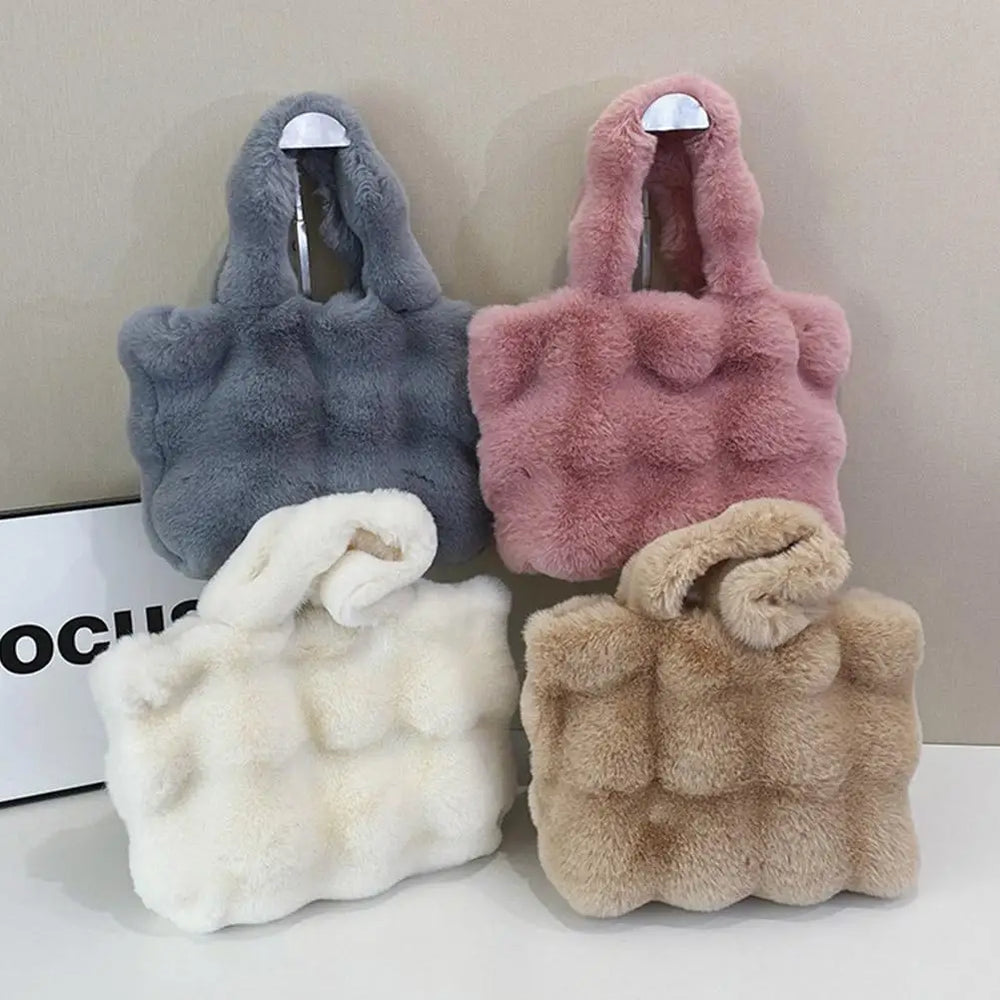 Faux fur bucket handbags in gray, pink, and beige with short loop handles