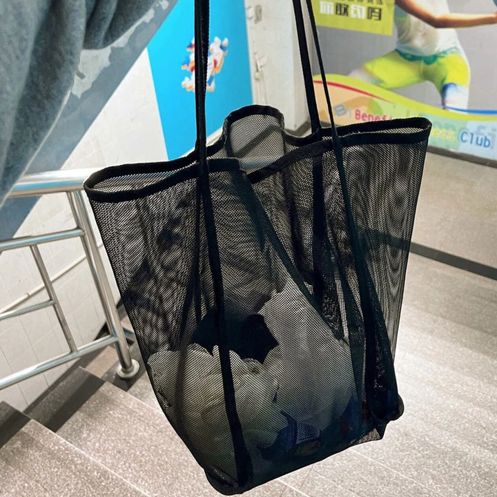 Black sheer mesh tote bag with open top and sturdy wide straps, front panel rows