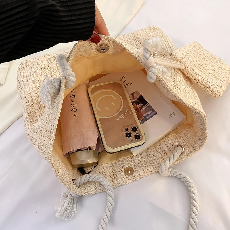 Beige drawstring bag with a phone case and other items on a white background