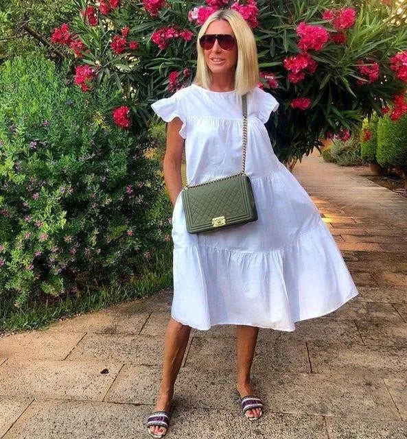 White tiered midi dress with short ruffle sleeves and gathered neckline