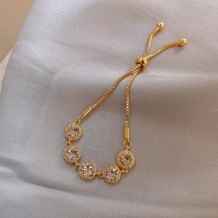 Gold-tone adjustable zircon bracelet with evenly spaced round stone links