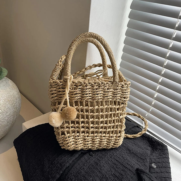 Khaki and beige knit straw bucket crossbody bag with pom-pom charms and rope handles