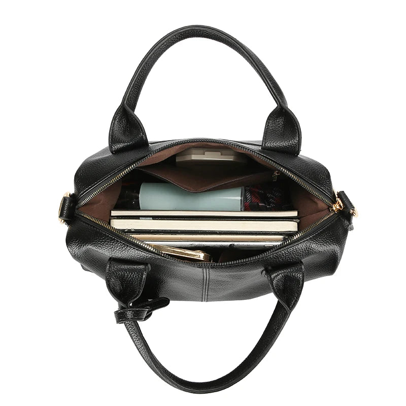Black soft leather tote bag with open top, zipper closure, and visible inner pocket
