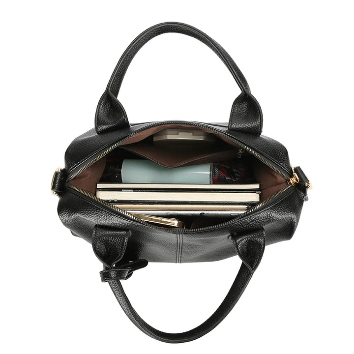 Black soft leather tote bag with open top, zipper closure, and visible inner pocket