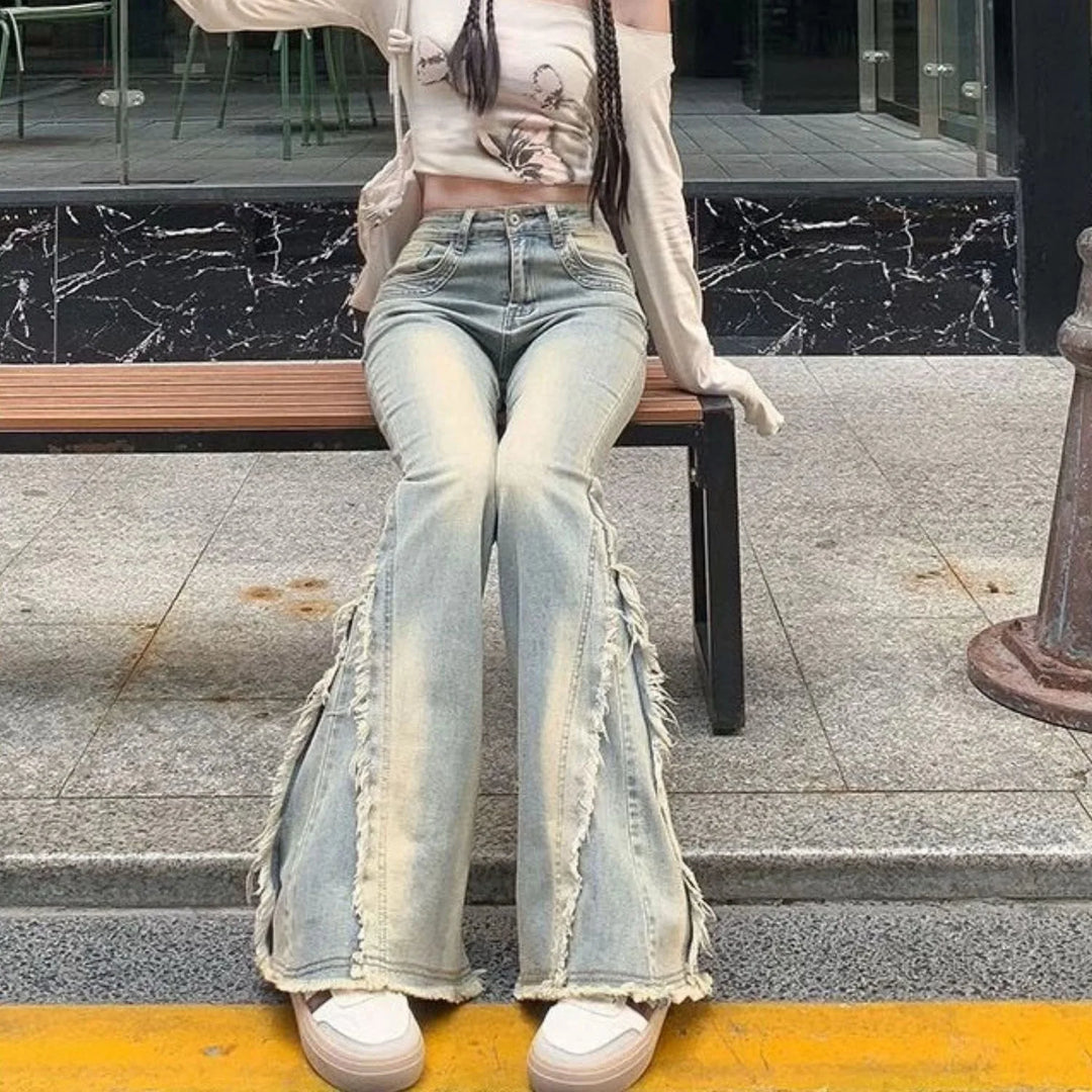 Light blue high-waist flared jeans with raw frayed hem and zipper fly