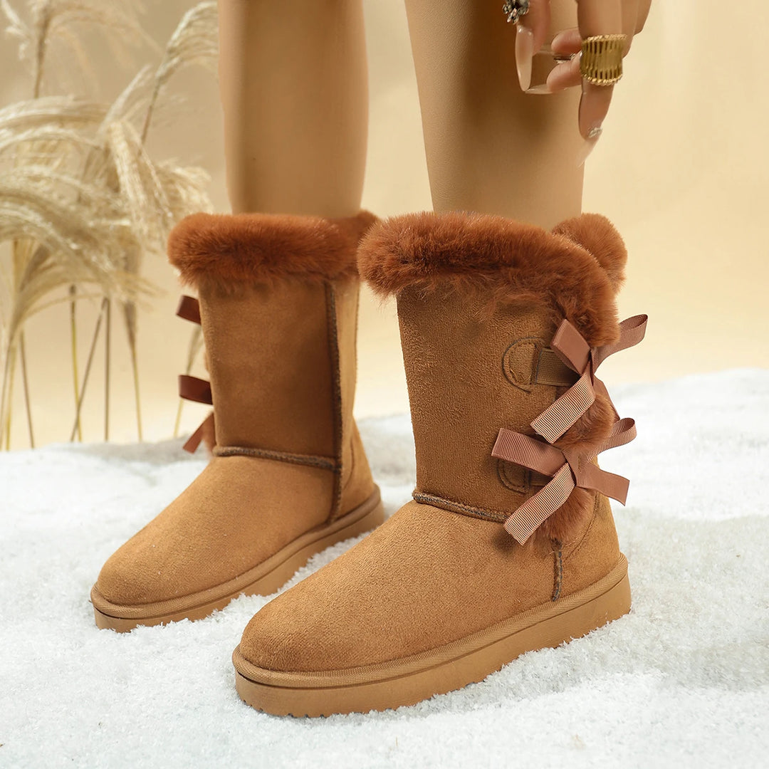 Tan mid-calf platform snow boots with plush faux-fur lining and side ribbon bows