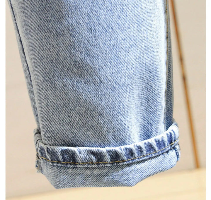 Women’s denim harem jeans cuff with rolled hem stitching, blue wash