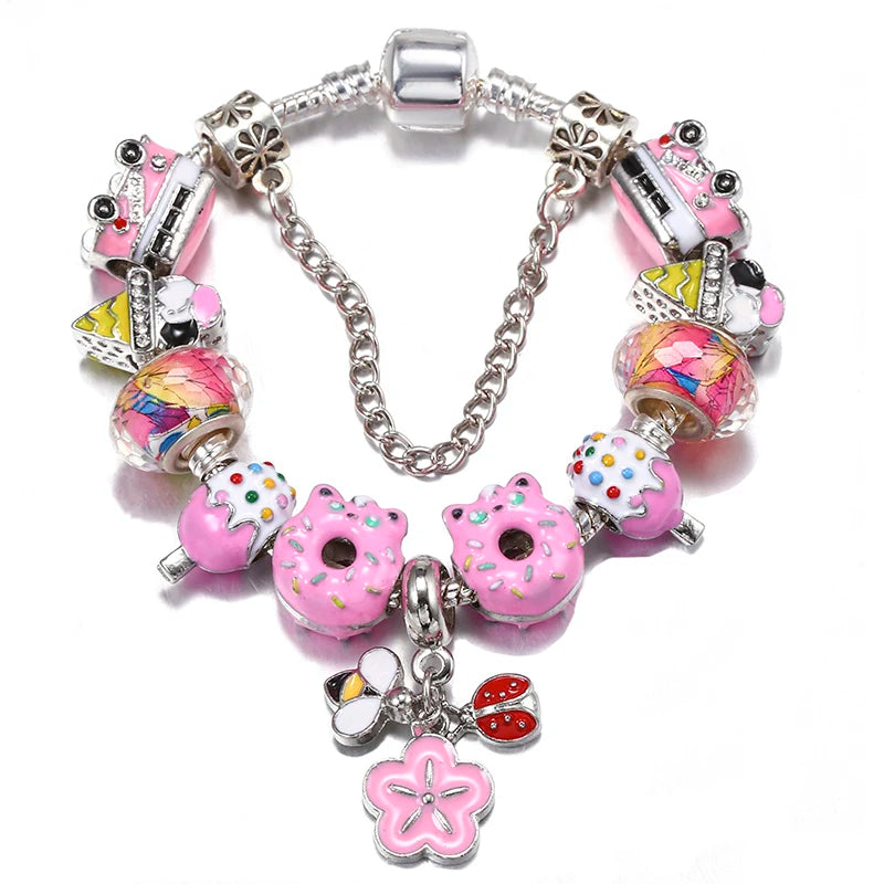 Silver charm bracelet with pink bead donuts, bow accents, and a flower charm