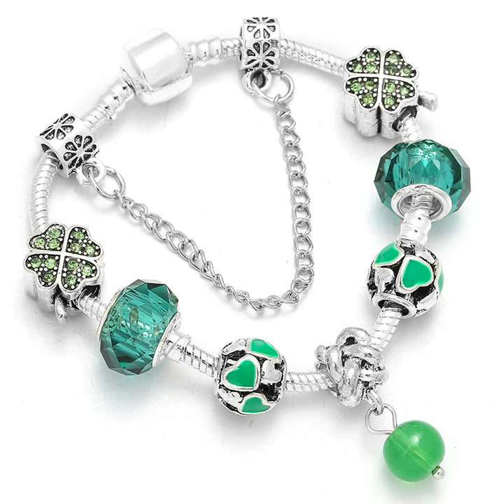 Silver bracelet with turquoise crystal beads, four-leaf charms, and green enamel heart