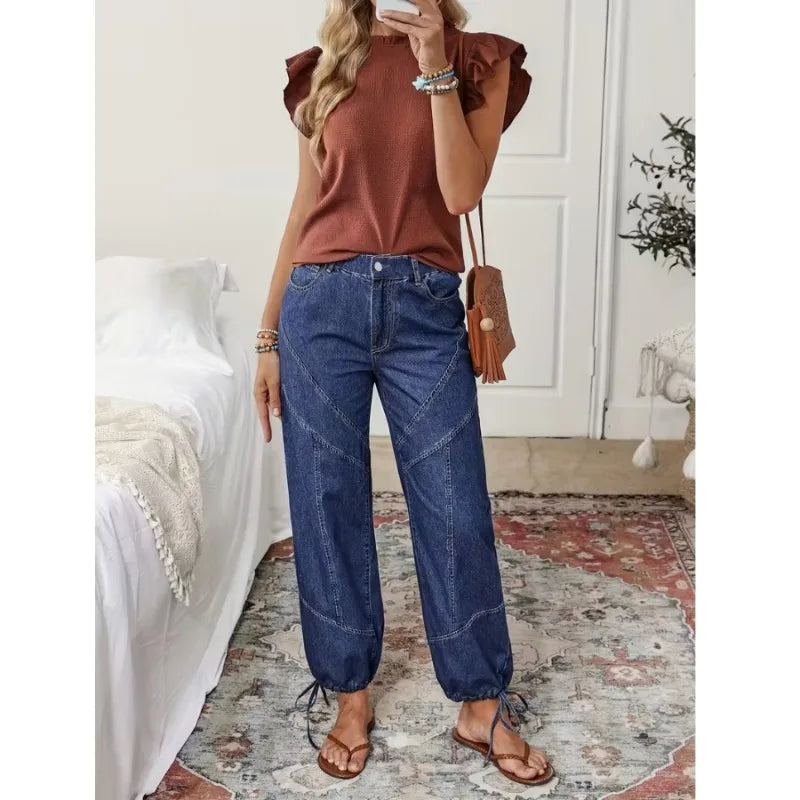 High-waist denim jeans, dark blue wash, loose fit with drawstring cuffs and front pockets