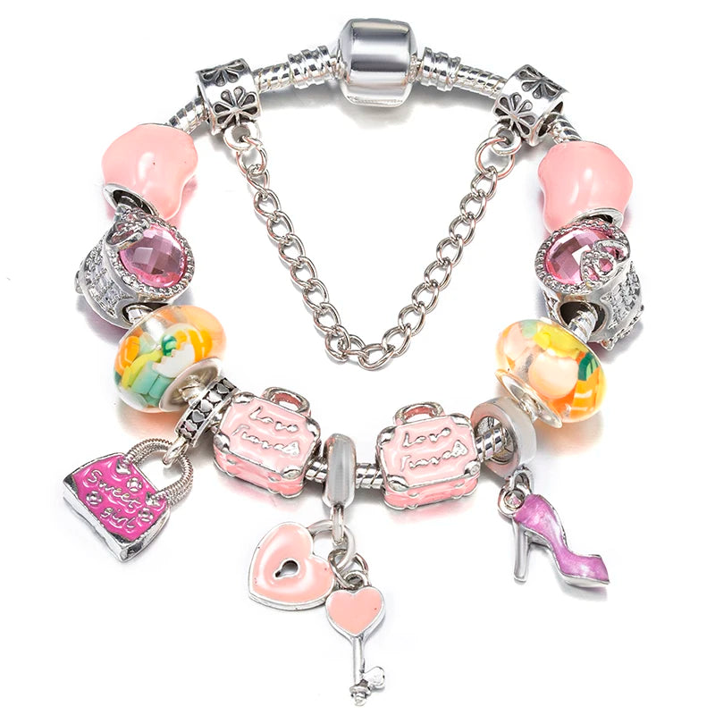 Silver charm bracelet with pale pink hearts, colorful glass beads, and a key charm