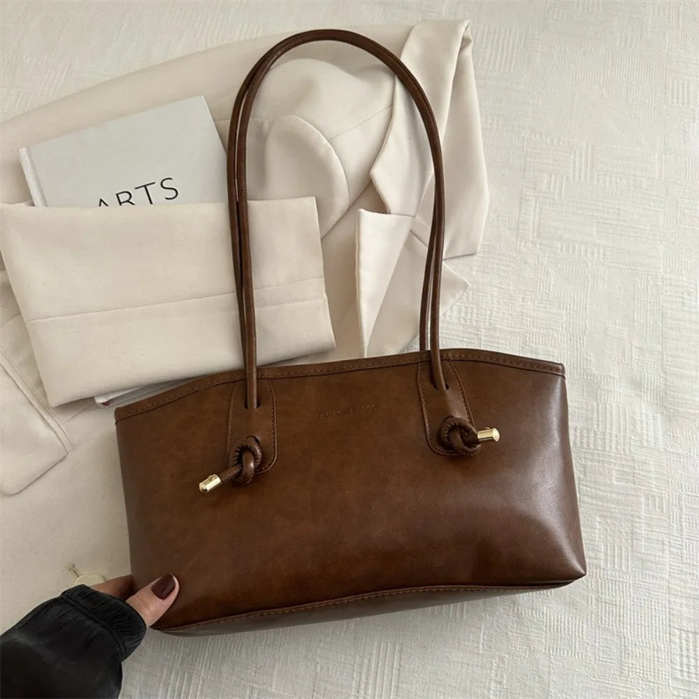 Brown PU leather tote handbag with long top handles and braided crossbody strap