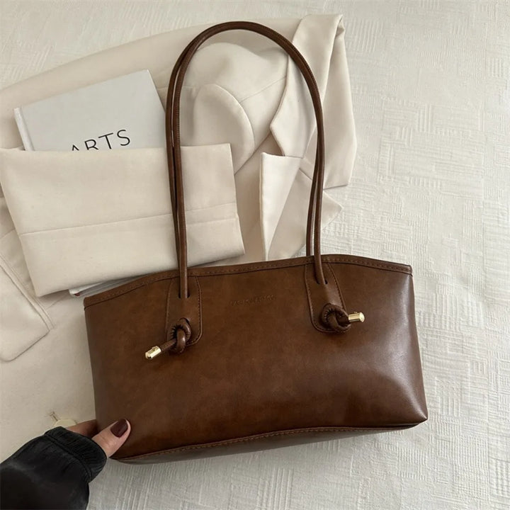 Brown PU leather tote handbag with long top handles and braided crossbody strap