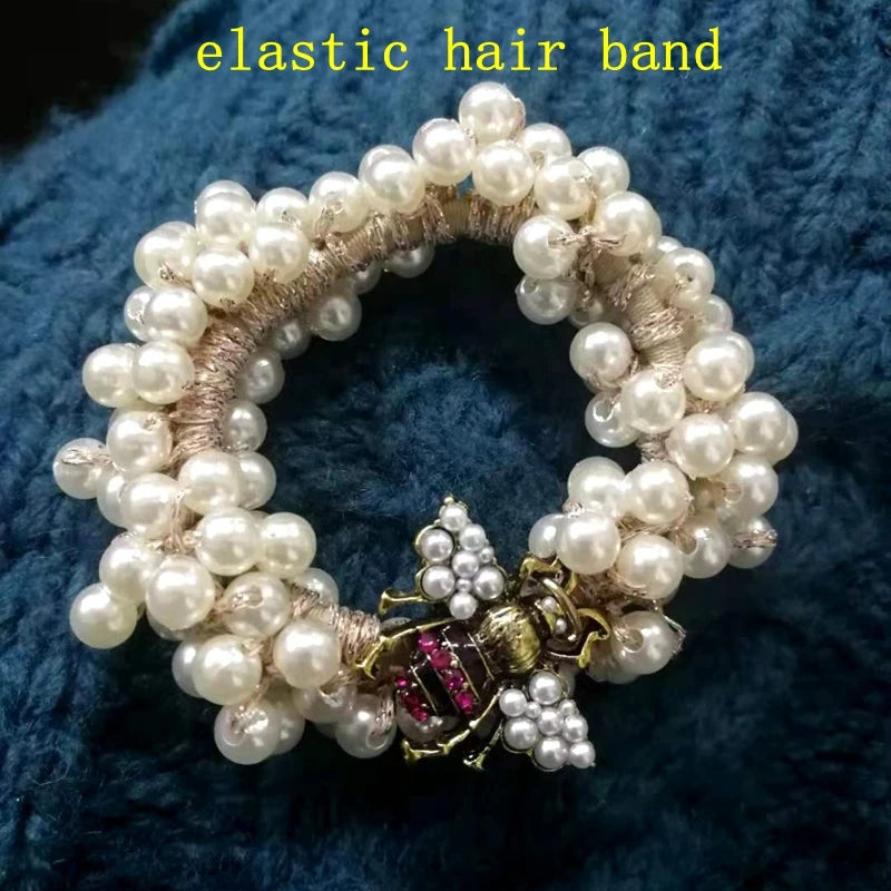 Pearl hair band with decorative element on a blue textured background