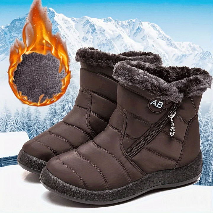 Brown winter boots with fur lining on a snowy mountain background