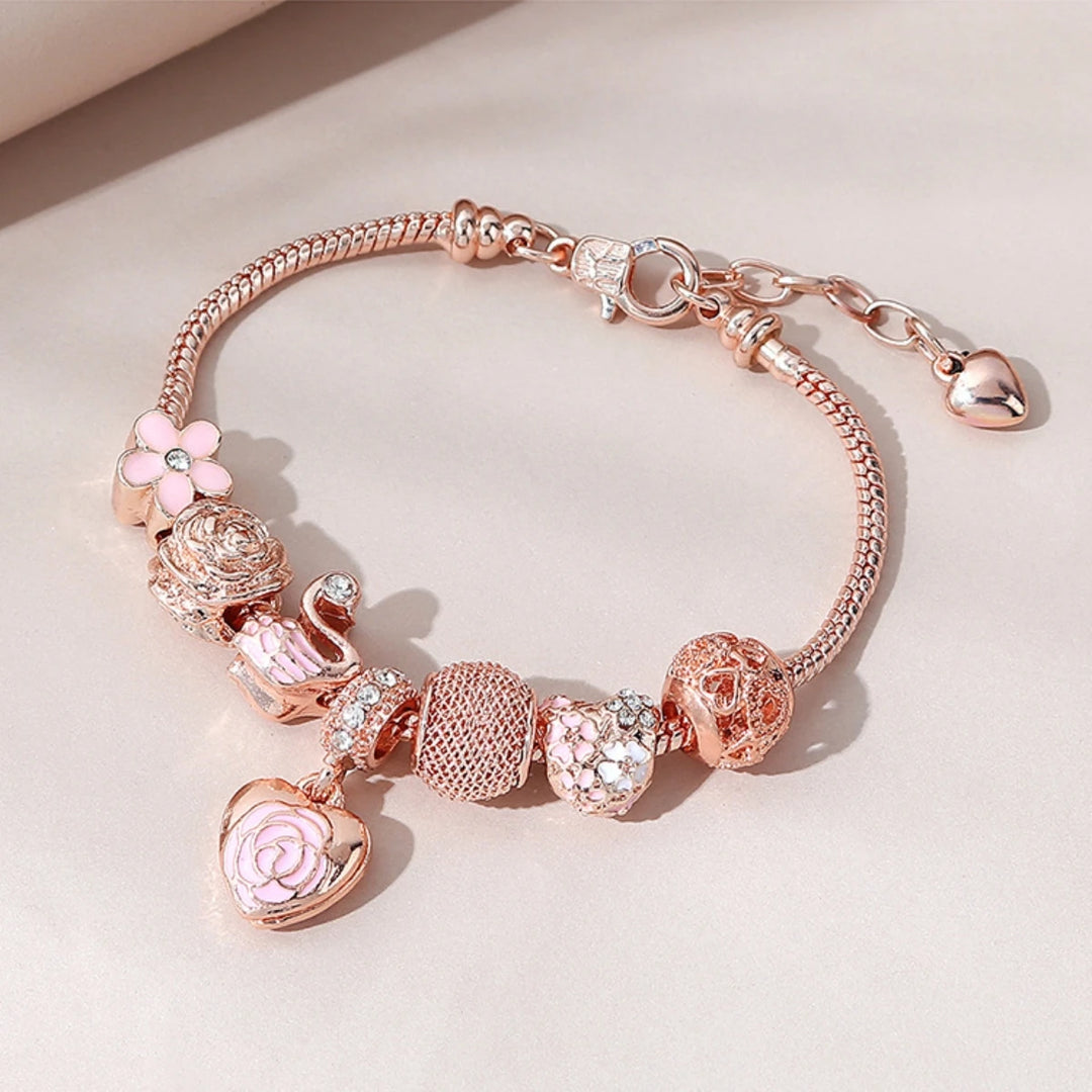 Rose gold charm bracelet with pink flower, rose bead, mesh spacer, and heart clasp charm