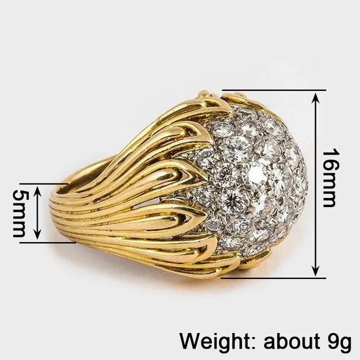 Gold ring with diamond cluster and measurements on a white background