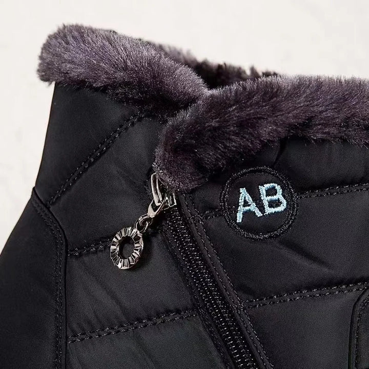 Black winter boot with fur trim and 'AB' logo on a white background