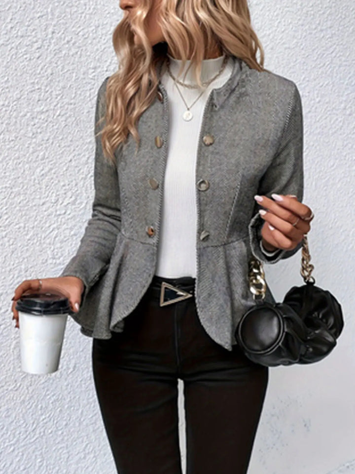 Gray double-breasted trench coat with peplum waist, gold-button front and long sleeves.