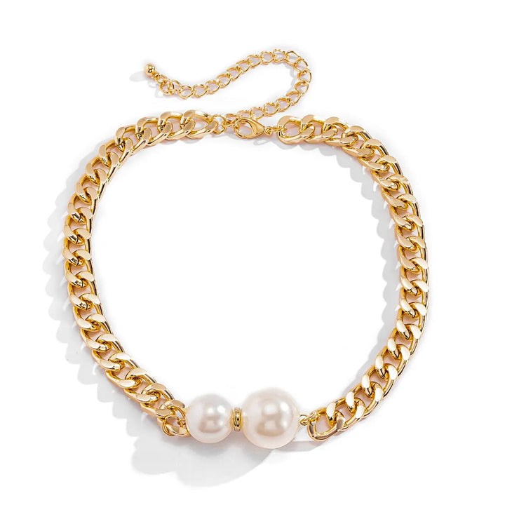 Gold chain necklace with pearls on a white background