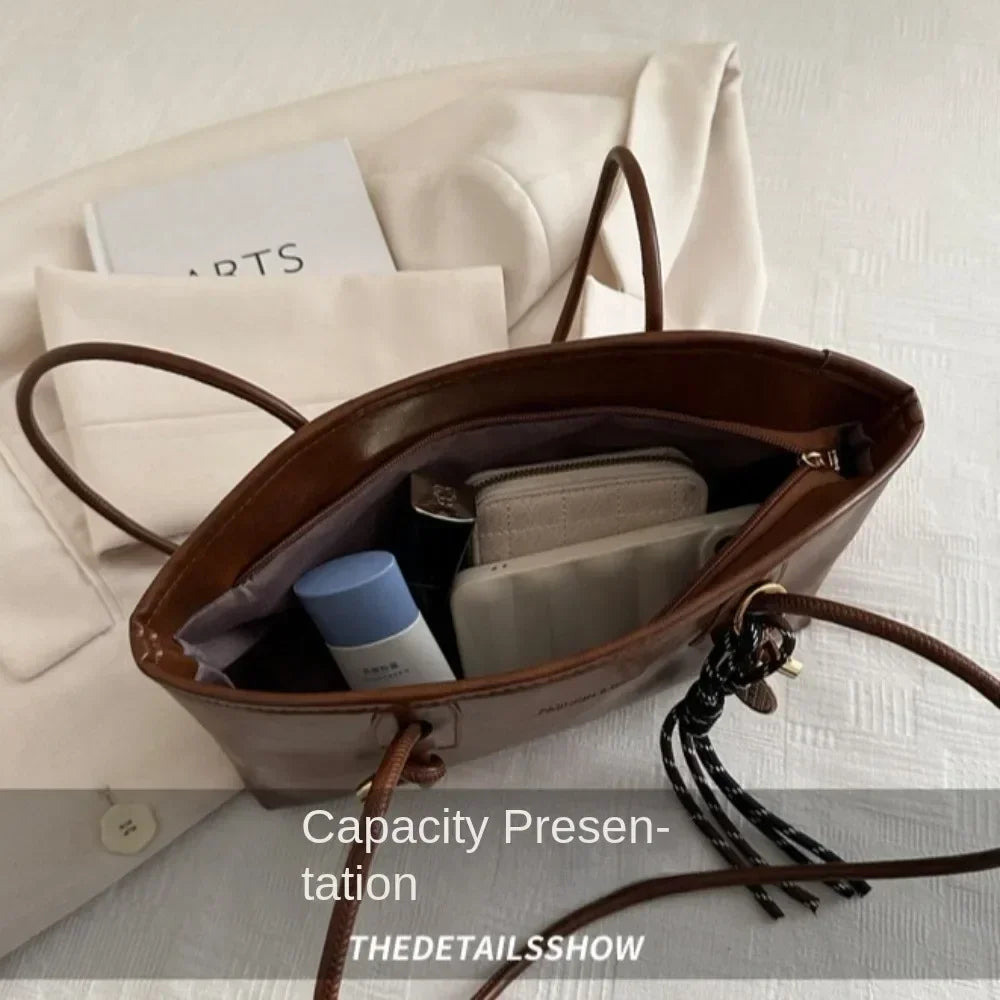 Brown PU leather crossbody tote handbag with open top and visible interior pockets