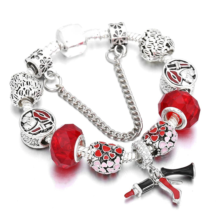 Silver bracelet with red crystal beads and bow and heart charms