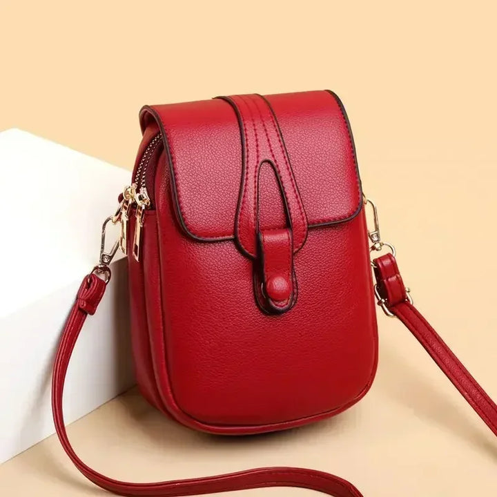 Small crossbody handbag in red with flap front and adjustable shoulder strap