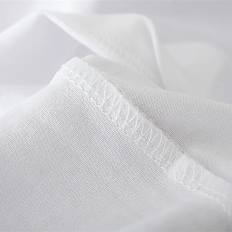 White tee fabric close-up showing stitched neckline detail