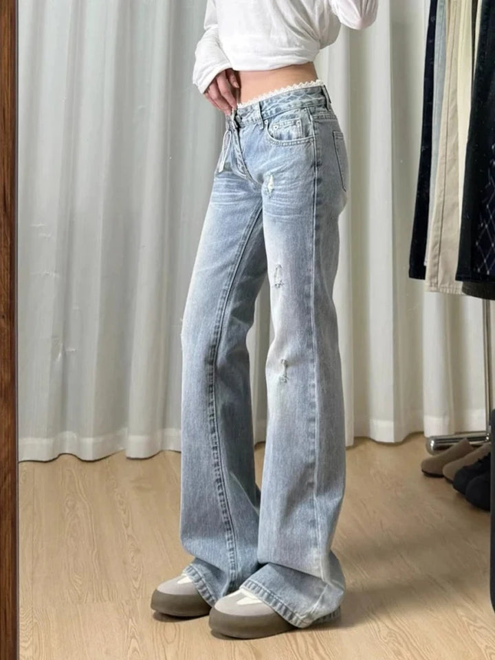 Light-wash mid-rise straight-leg plus-size jeans with distressed knee rips and cuffed hems