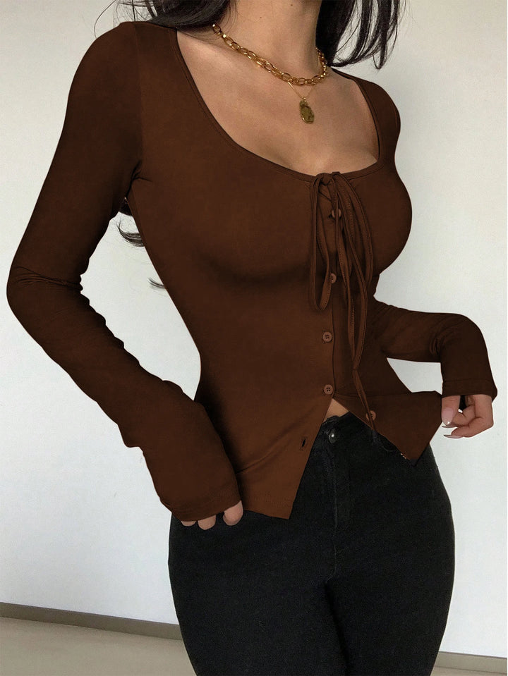 Brown long-sleeve top with a tie detail worn by a person against a plain background